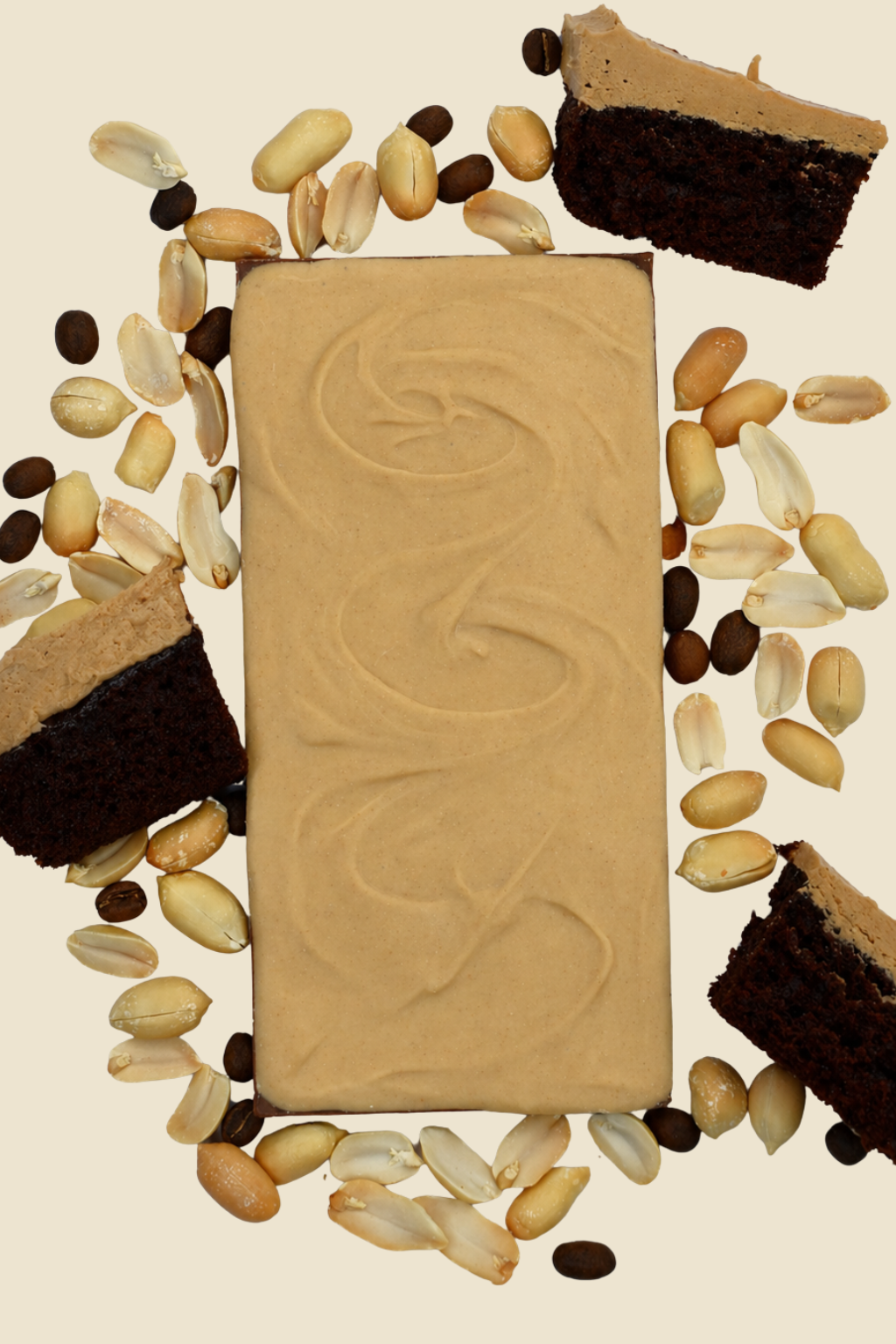 Chocolate and peanut butter bar surrounded by chocolate, cake pieces, coffee beans and nuts on a beige background
